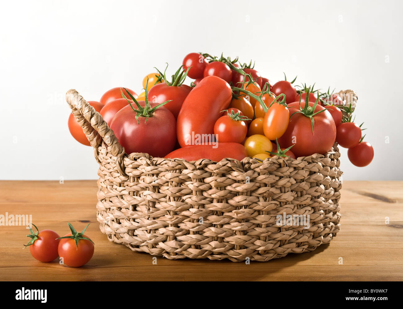 A basket with a variation of tomatoes Stock Photo