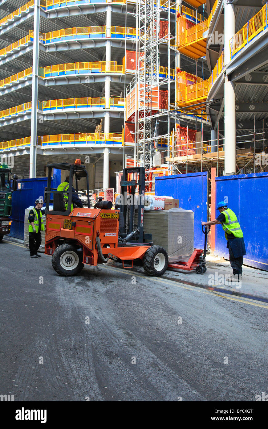Forklift delivering building materials onsite Stock Photo