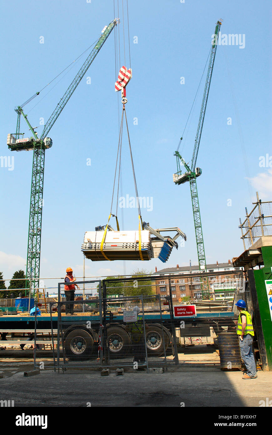 Crane lifting construction materials form a lorry Stock Photo Alamy