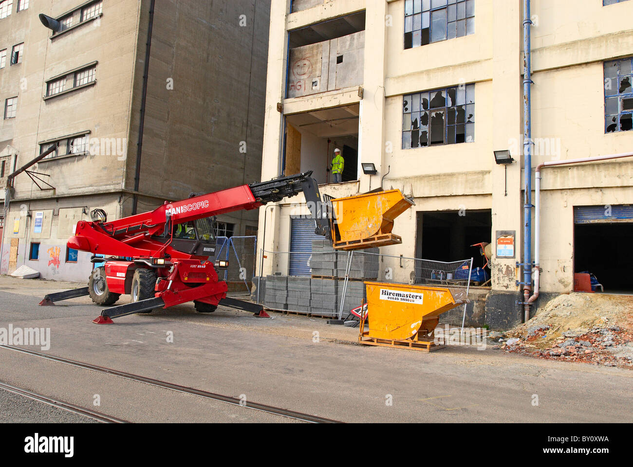 Forklift with mini skip operated by remote control on a demolition site ...