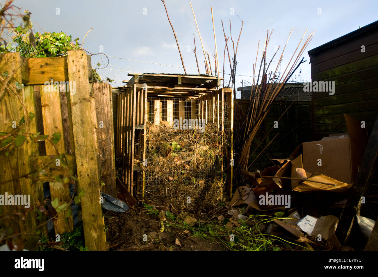 A Compost Heap built from wooden pallets with cardboard ready to be