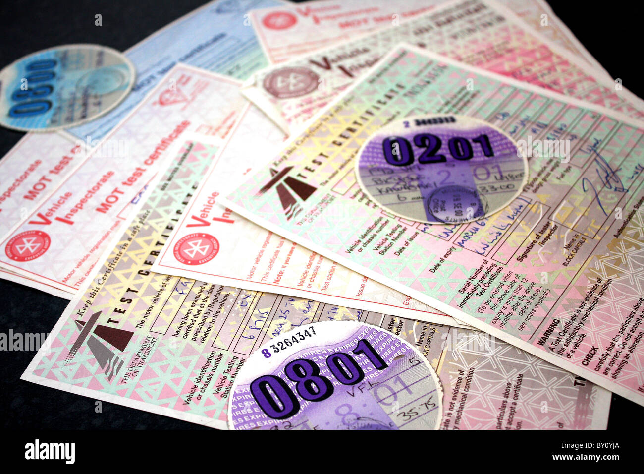 A collection of car and motorbike tax discs and MOT vehicle inspection