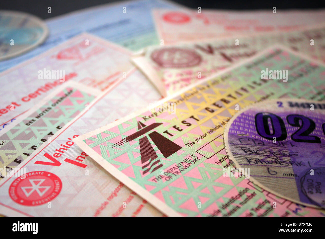 A collection of car and motorbike tax discs and MOT vehicle inspection