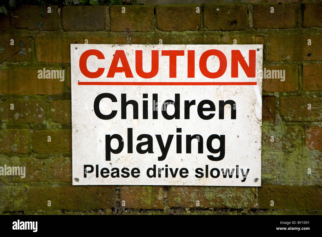 Sign Caution children playing please drive slowly Stock Photo