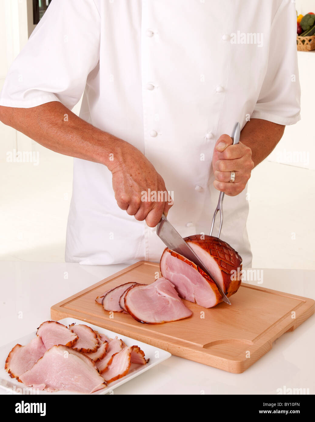 CHEF SLICING HAM Stock Photo