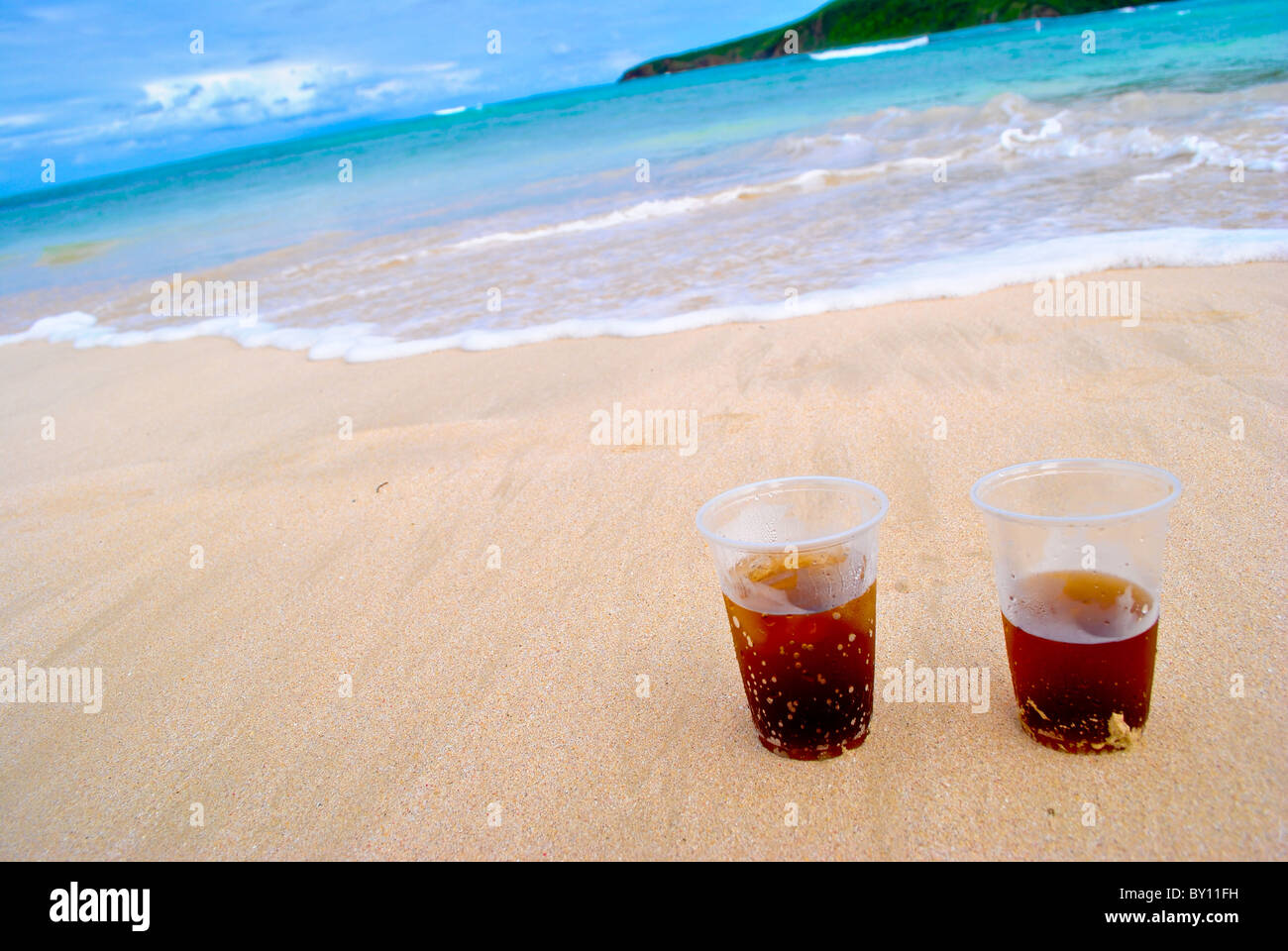 Two rum glasses on the beach. Stock Photo