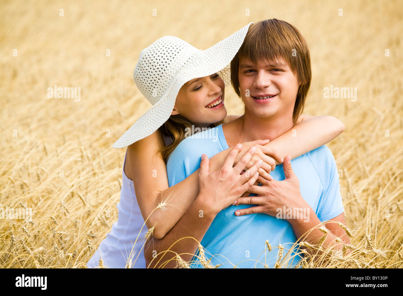 Image of tender girl hugging her boyfriend and looking at him lovingly ...