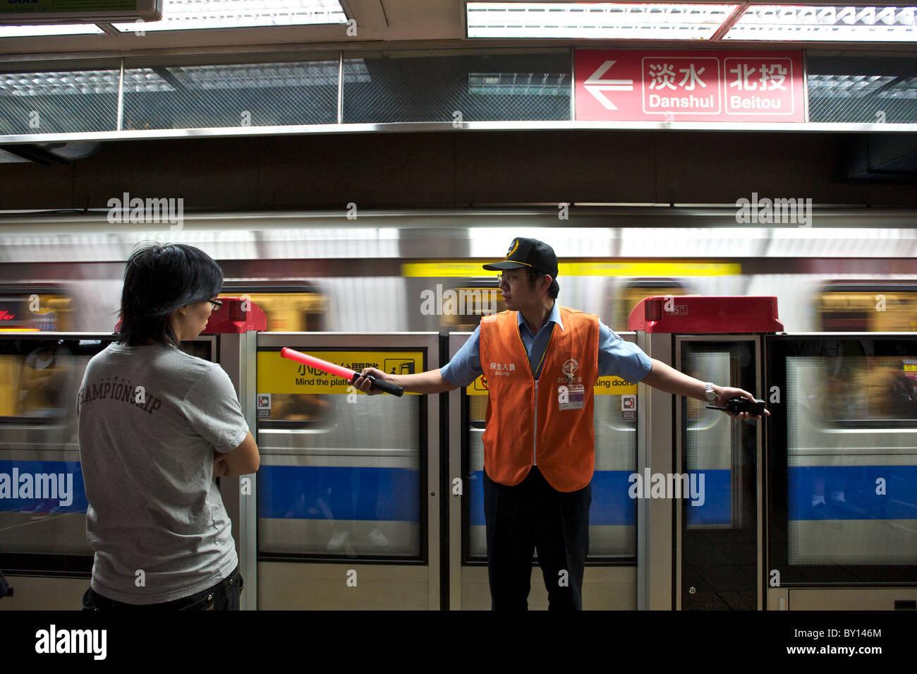 A transit worker at a subway stop in Taipei, Taiwan. Stock Photo