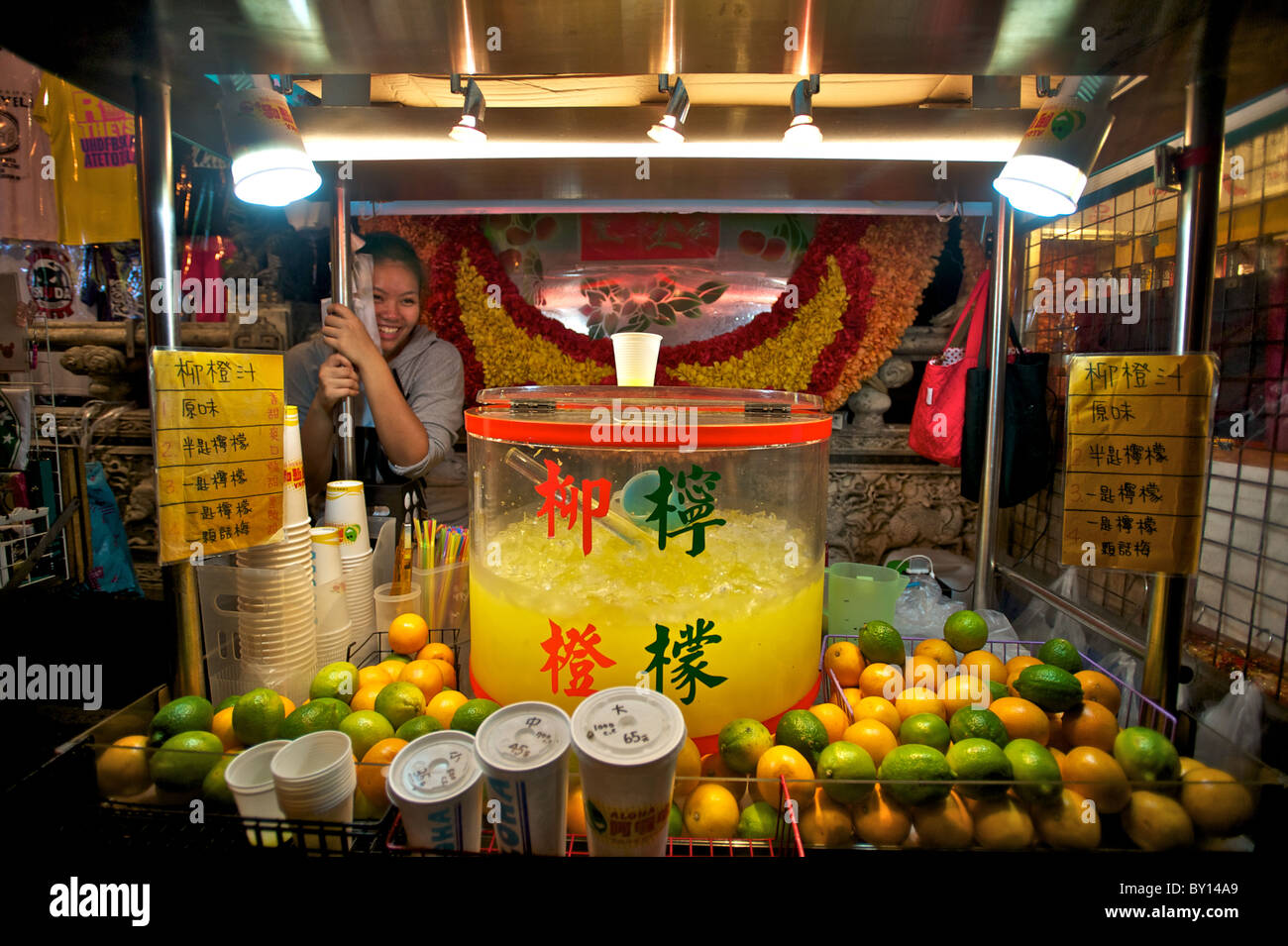 A vendor with her juice stand at a night market in Taipei, Taiwan. Stock Photo
