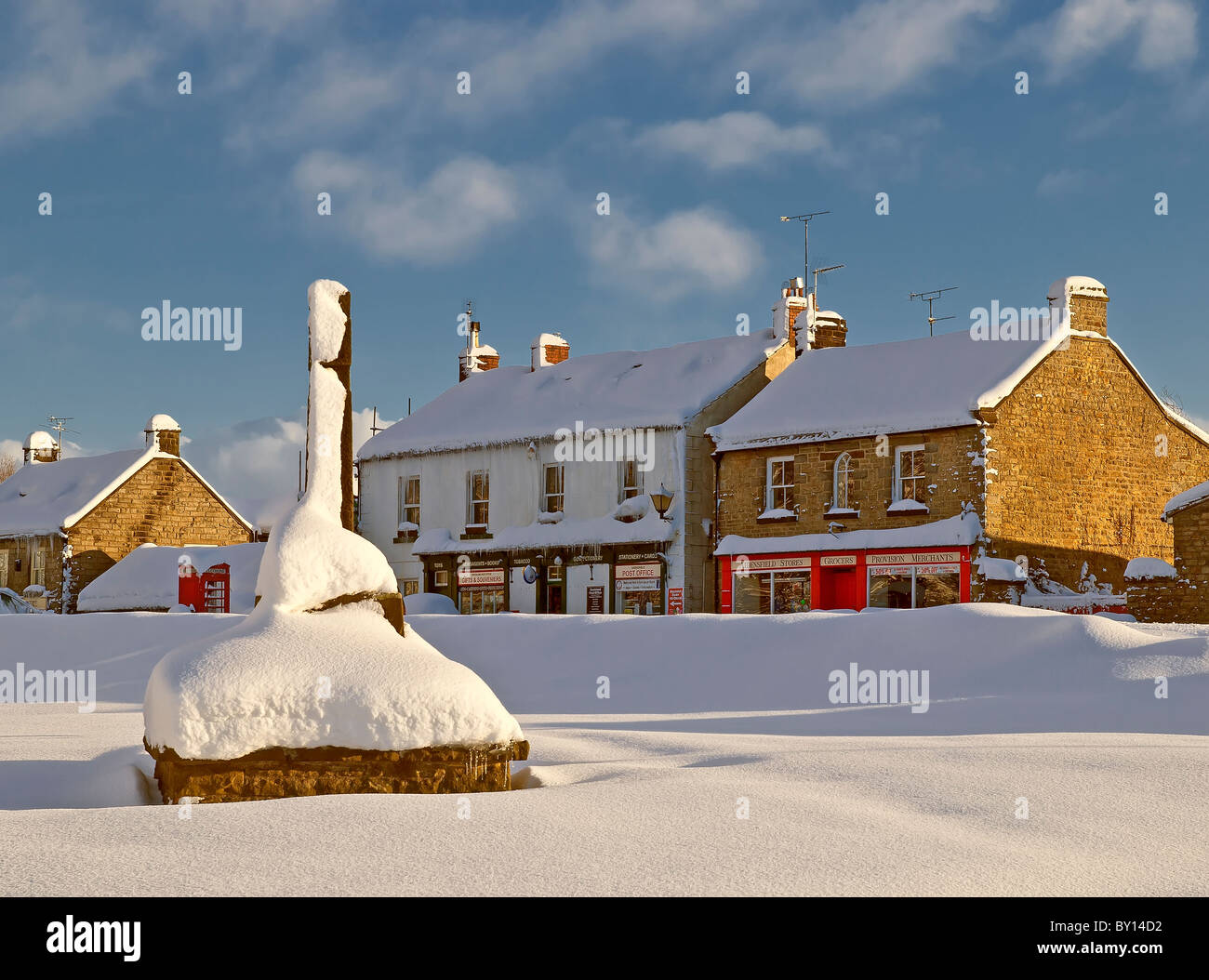 View of Goathland showing shops and war memorial in deep snow. Stock Photo