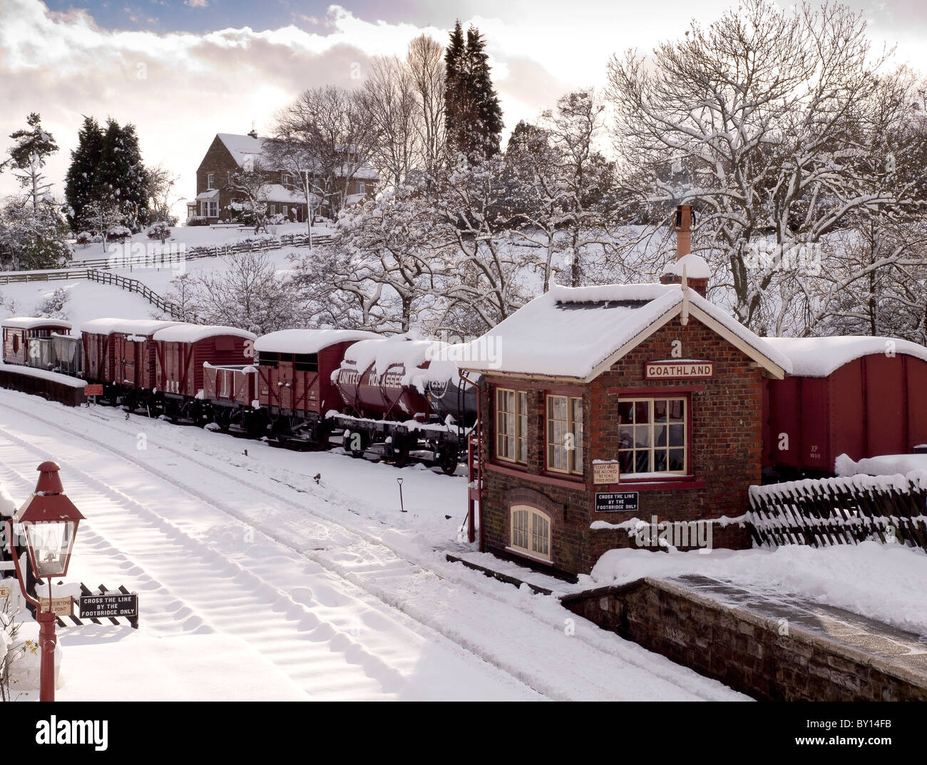 Signal box and rolling stock under blanket of snow at Goathland Stock Photo
