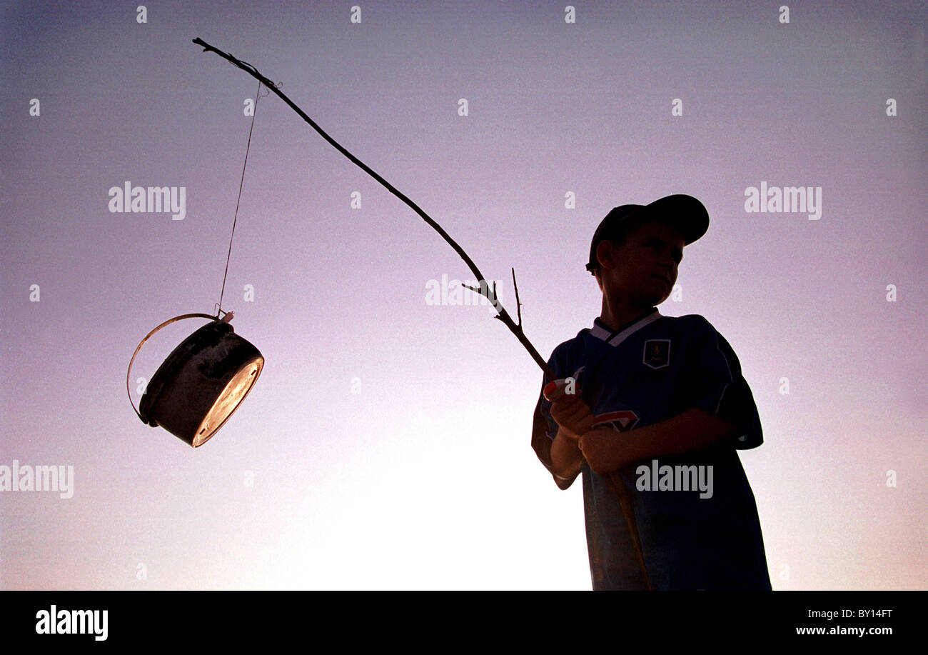 A boy fishes using a makeshift fishing rod, Cardiff Bay Stock Photo - Alamy