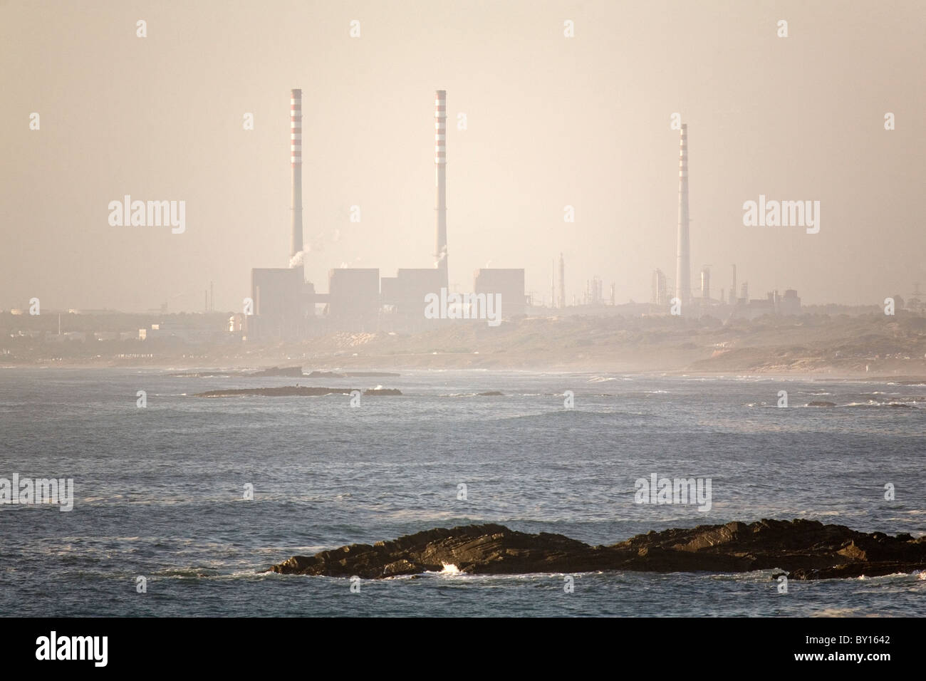 The chimneys of industrial plants at Sines on Portugal's Alentejo coast. Stock Photo