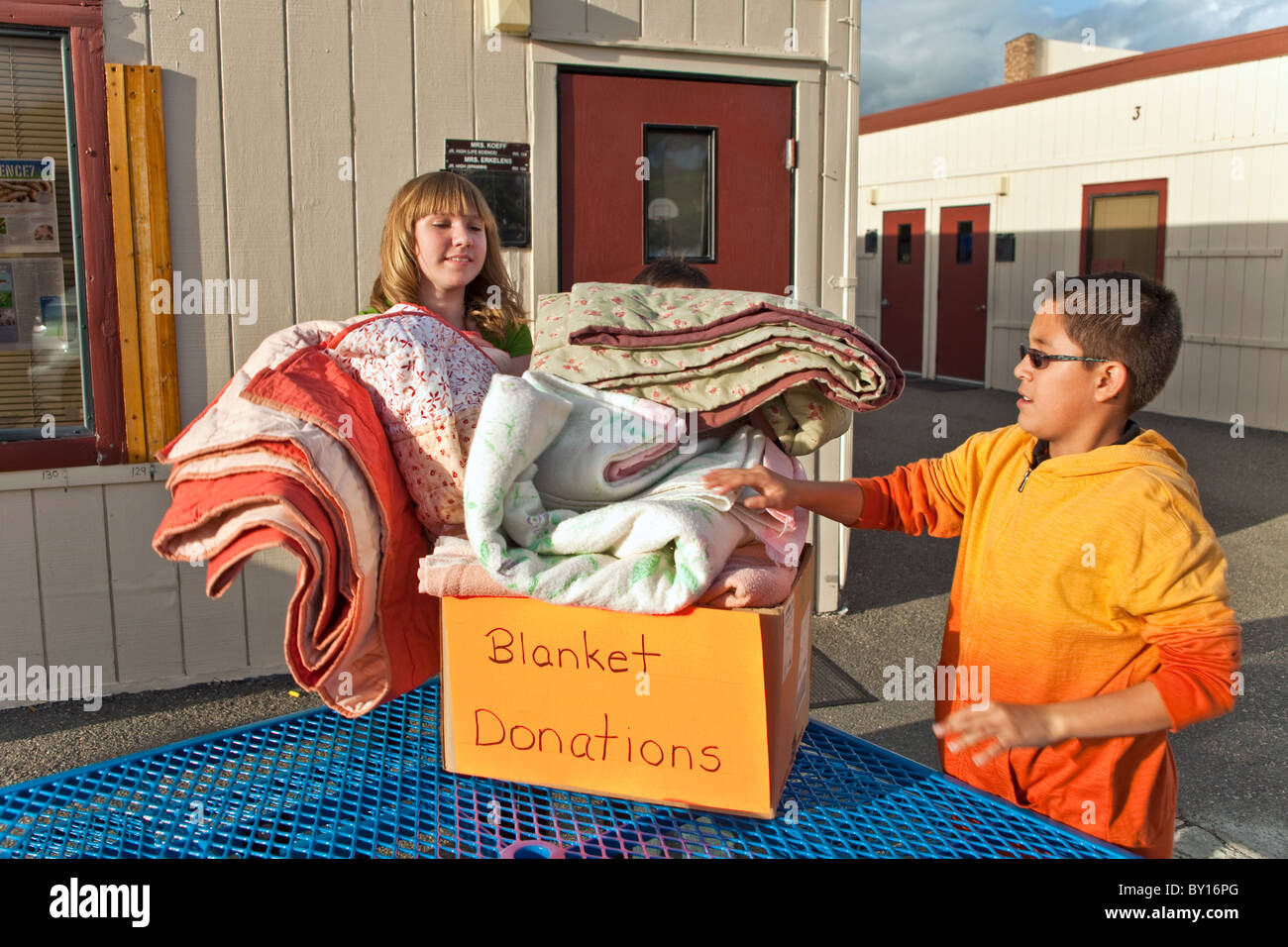 multi ethnic multi racial diversity racially diverse multicultural multi cultural group Middle school kids collect blankets for poor people.MR © Stock Photo