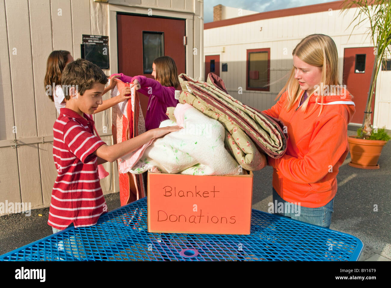 multi ethnic multi racial diversity racially diverse multicultural multi cultural group Middle school kids collect blankets for needy people. MR © Stock Photo