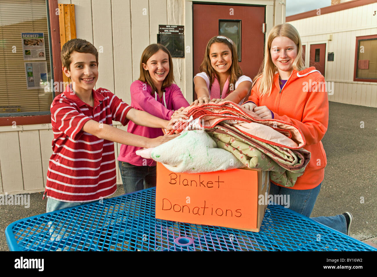 Project multi ethnic multi racial diversity racially diverse multicultural multi cultural group Middle school collect blankets for poor people. MR © Stock Photo
