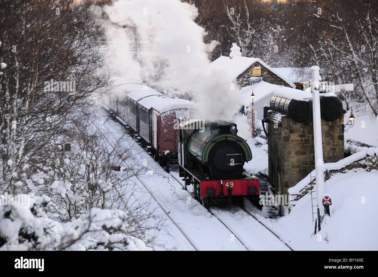 steam locomotive bellowing steam in the snow Stock Photo