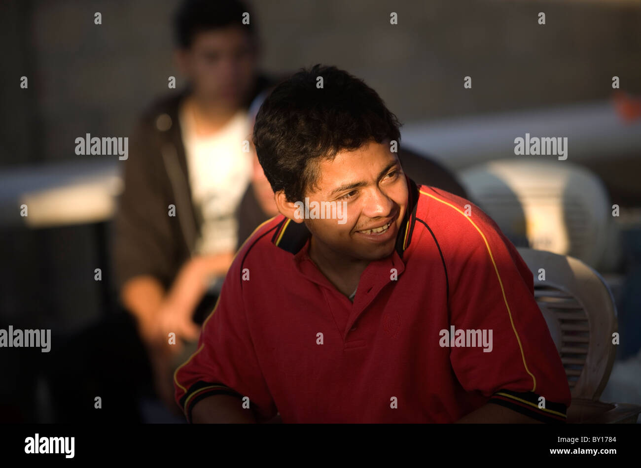 A Central American migrant smiles in a shelter located along the railroad in Ixtepec, Oaxaca, Mexico. Stock Photo