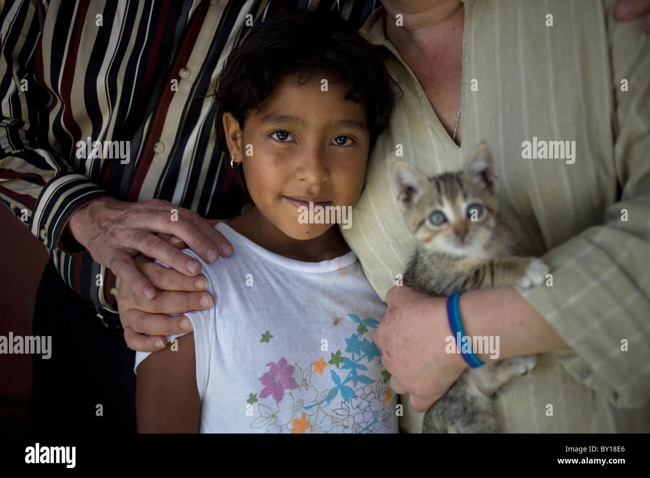 A Central American migrant girl pose for a picture in a shelter located along the railroad in Ixtepec, Oaxaca, Mexico. Stock Photo