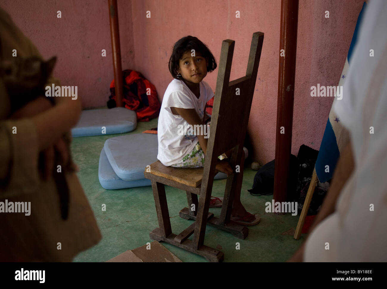 A Central American migrant girl sits in a shelter located along the railroad in Ixtepec, Oaxaca, Mexico. Stock Photo