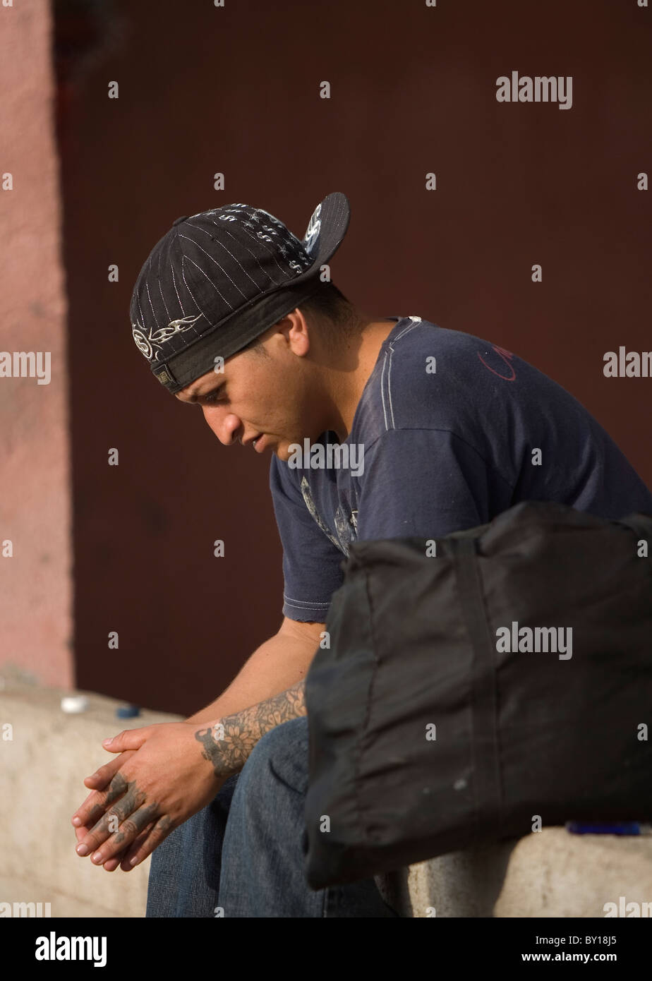 A Central American migrant sits in a shelter located along the railroad in Ixtepec, Oaxaca, Mexico. Stock Photo