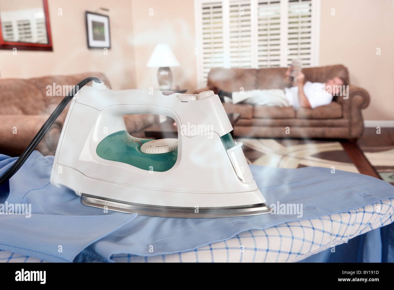 A man reads his newspaper and about the steaming hot iron that