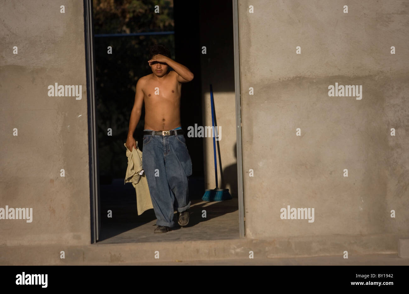 A Central American migrant  walks in a shelter located along the railroad in Ixtepec, Oaxaca, Mexico. Stock Photo