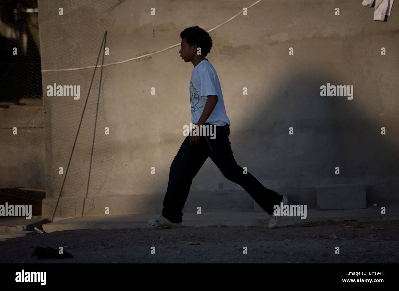 A Central American migrant walks in a shelter located along the railroad in Ixtepec, Oaxaca, Mexico. Stock Photo