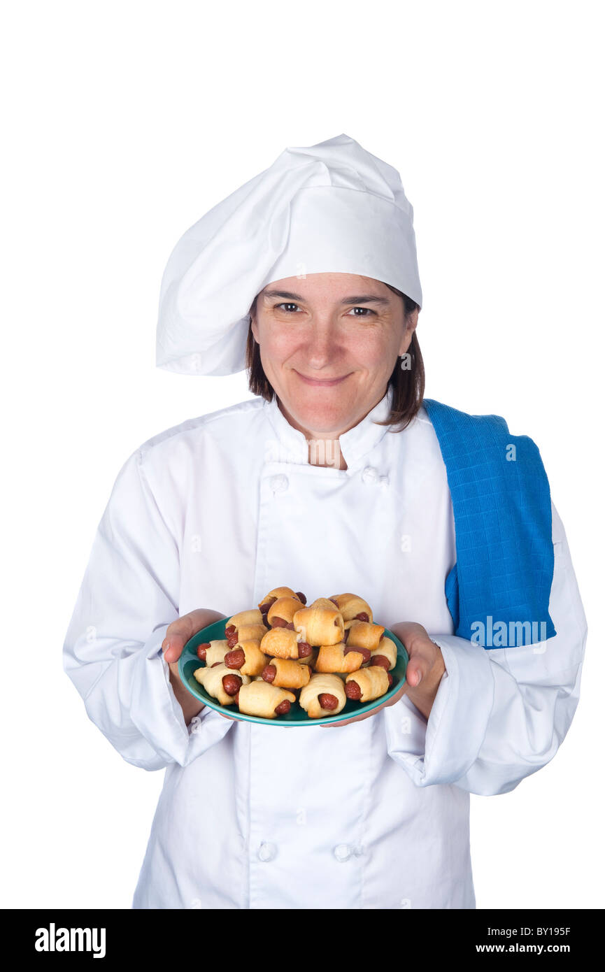 A female chef shows off her latest meal. Isolated on white for designer convenience. Stock Photo