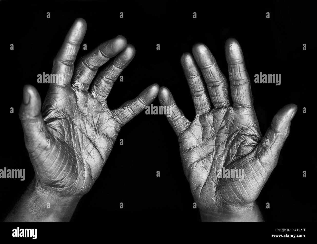 Close-up of woman's silver wrinkled hands, studio shot Stock Photo