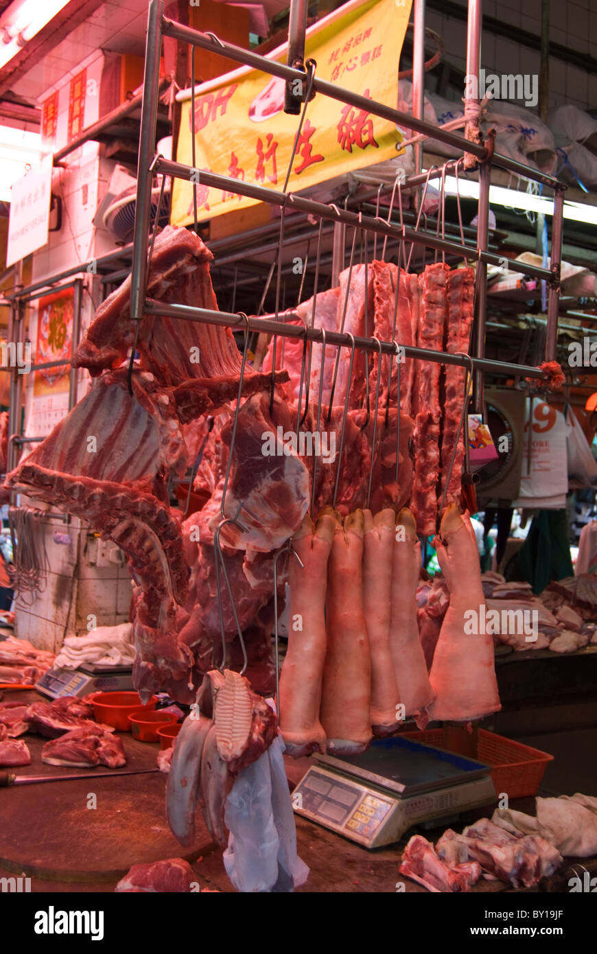 Fresh meat hanging in front of a shop in a market, Hong Kong Stock Photo