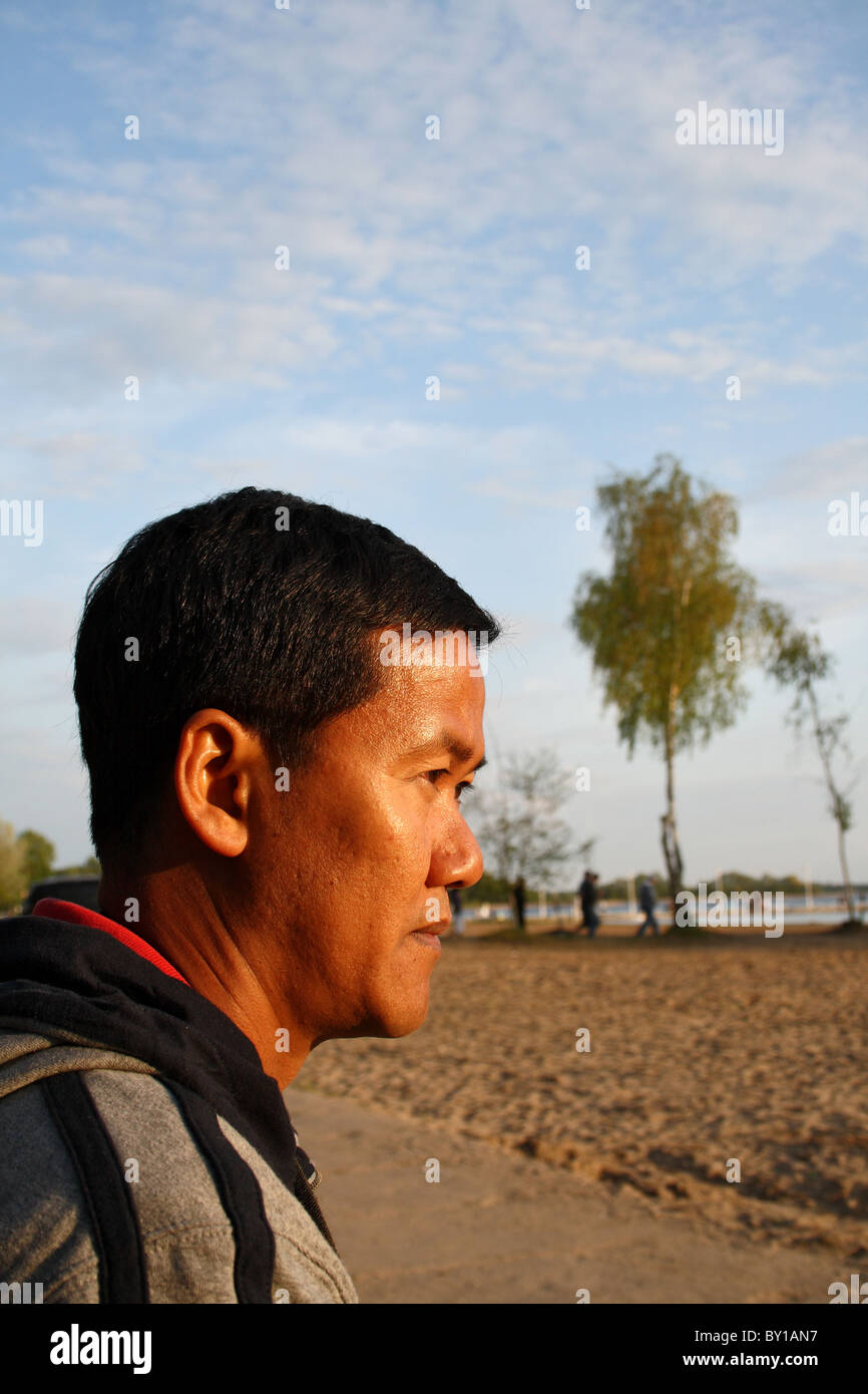 A Thai man at a lake, Skorzecin, Poland Stock Photo