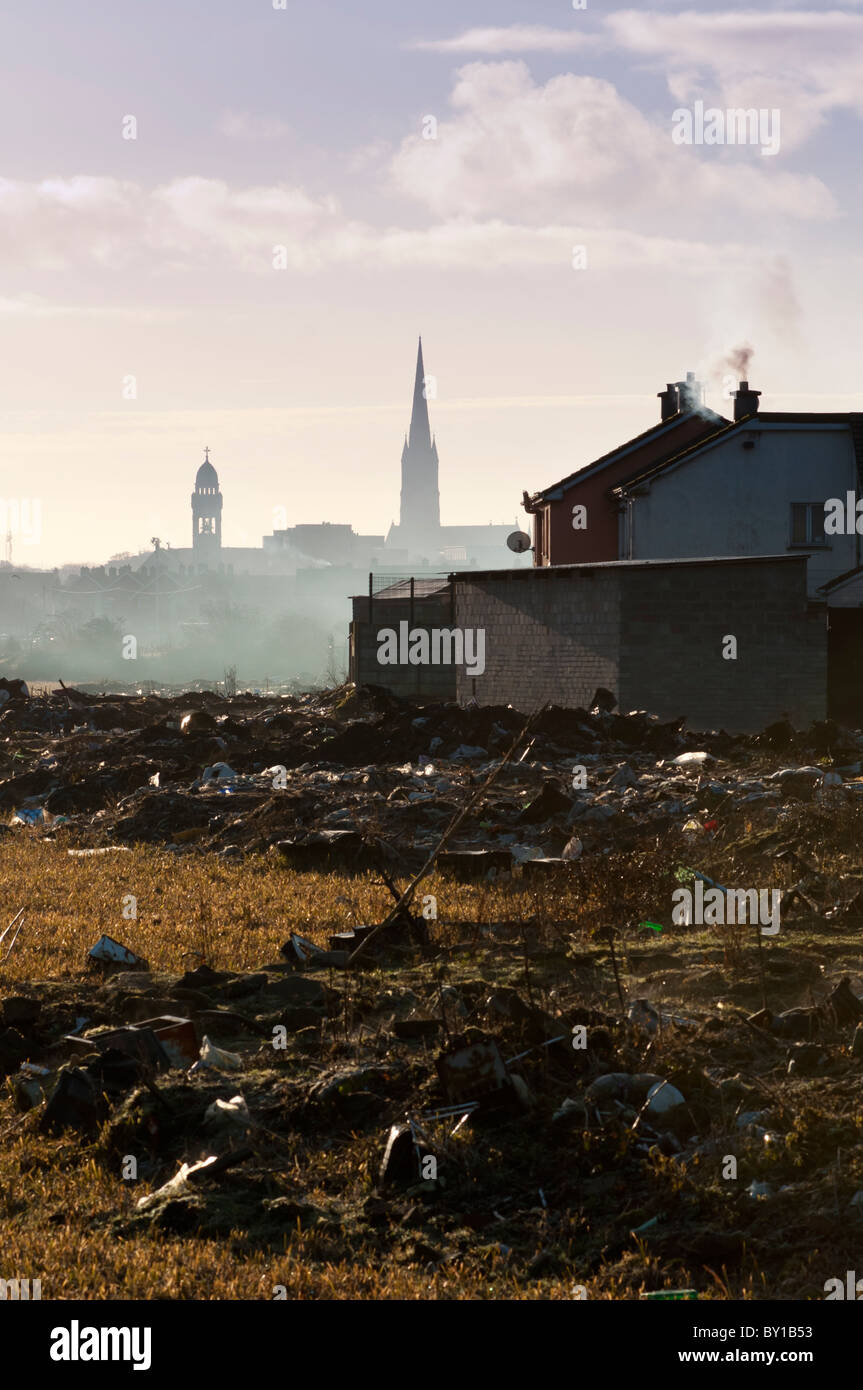 A distant Limerick city centre skyline with dumped rubbish near a
