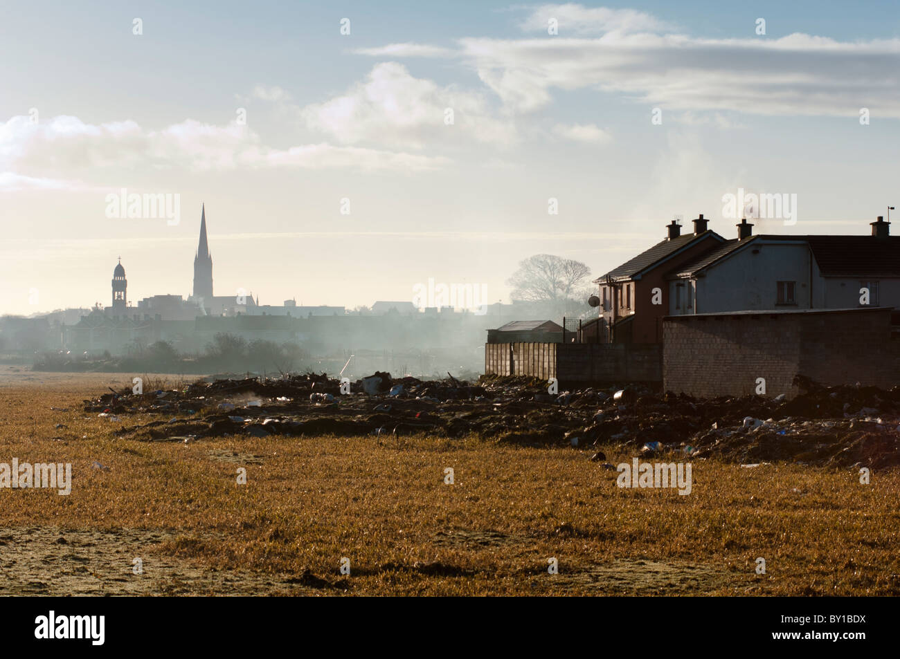 A distant Limerick city centre skyline with dilapidated housing and