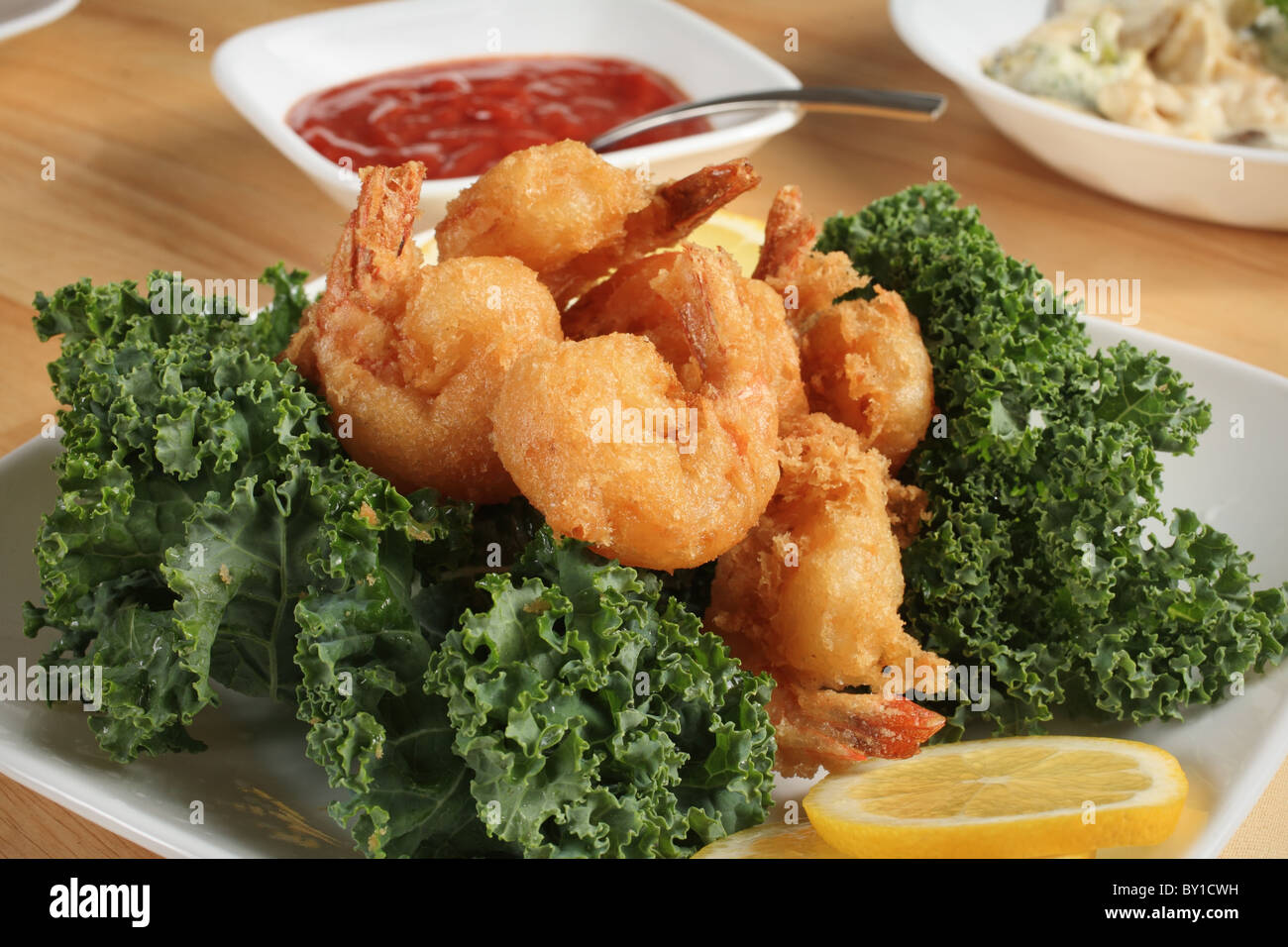 fried shrimp dinner with sauce and pasta bowl Stock Photo