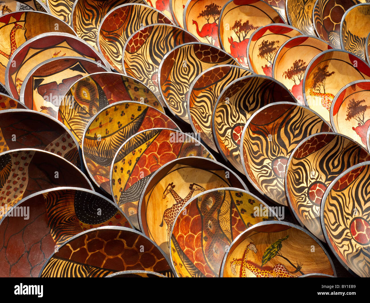 Decorated hand made wooden bowls carved from the wood of indigenous African trees Stock Photo