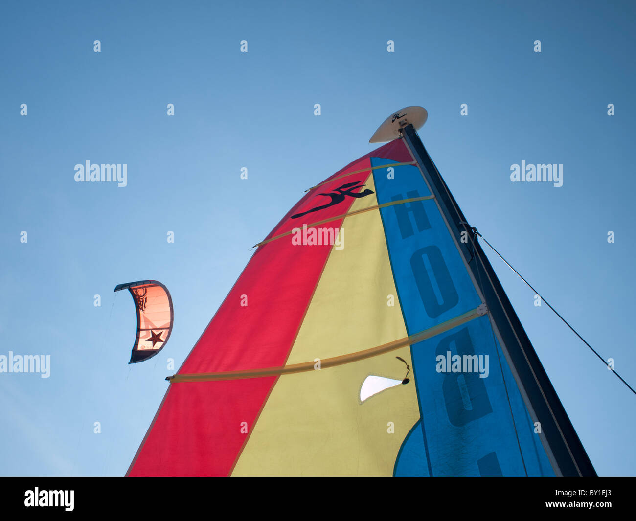 Top of a sail boat and kitesurf sail on the back ground Stock Photo