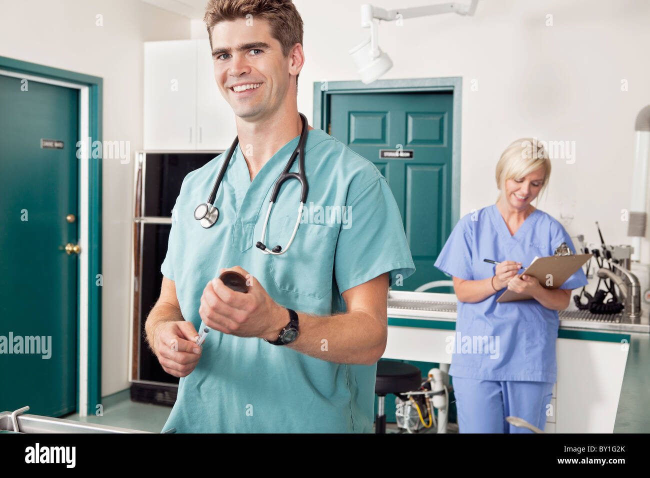 Doctor with female assistant in preparation for treatment Stock Photo