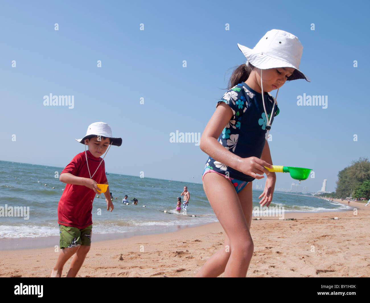 A kids taking sea water by using the spade Stock Photo