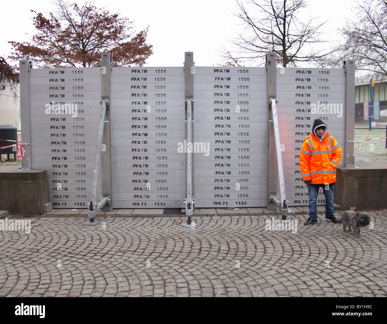 Installing flood defence barriers beside River Rheine in central