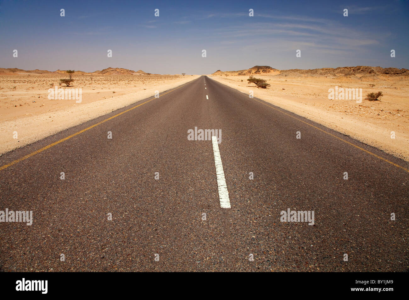 Oman. An empty highway through Oman's barren lands. Stock Photo