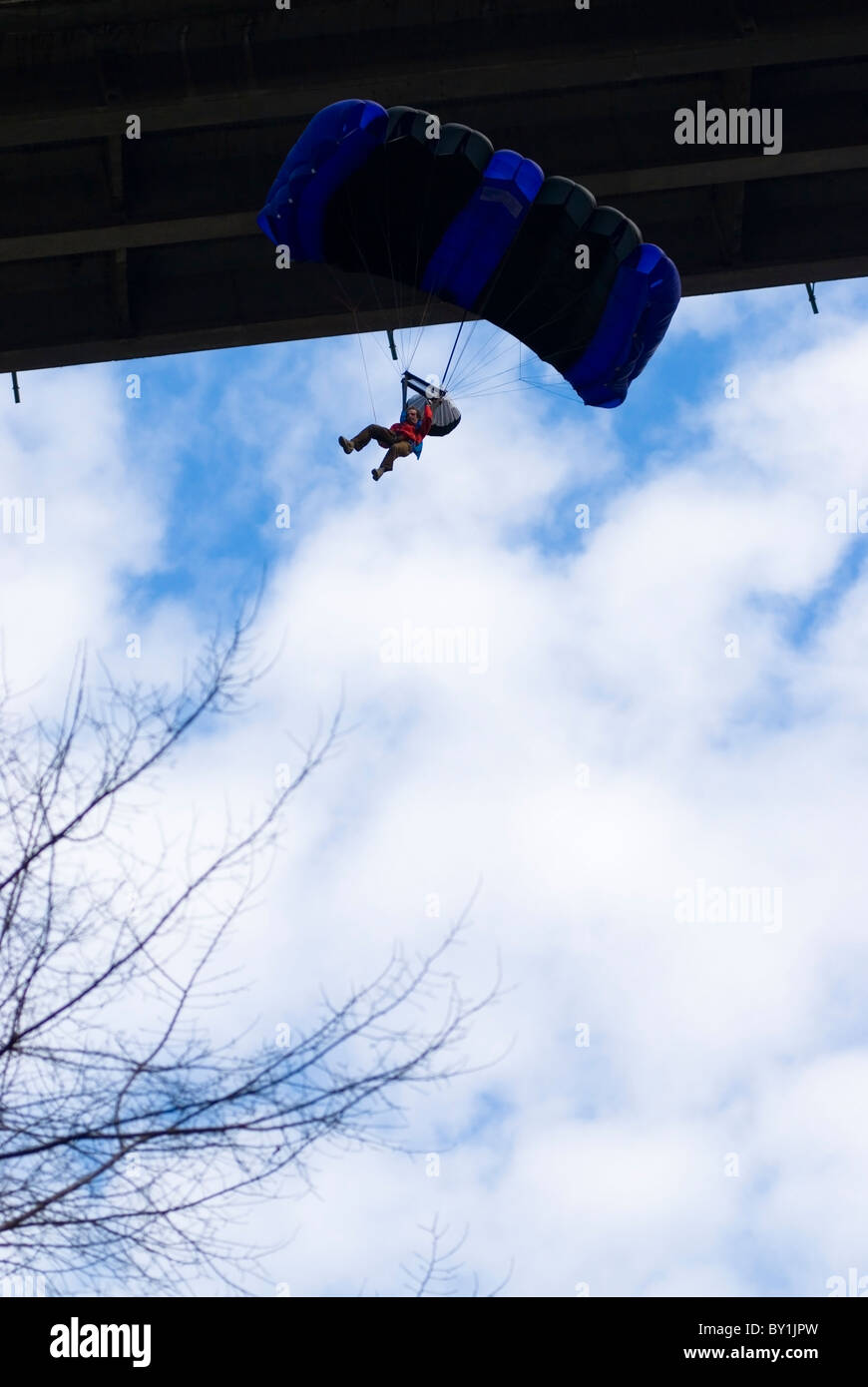 BASE jumper with an open parachute after leaping off a bridge Stock