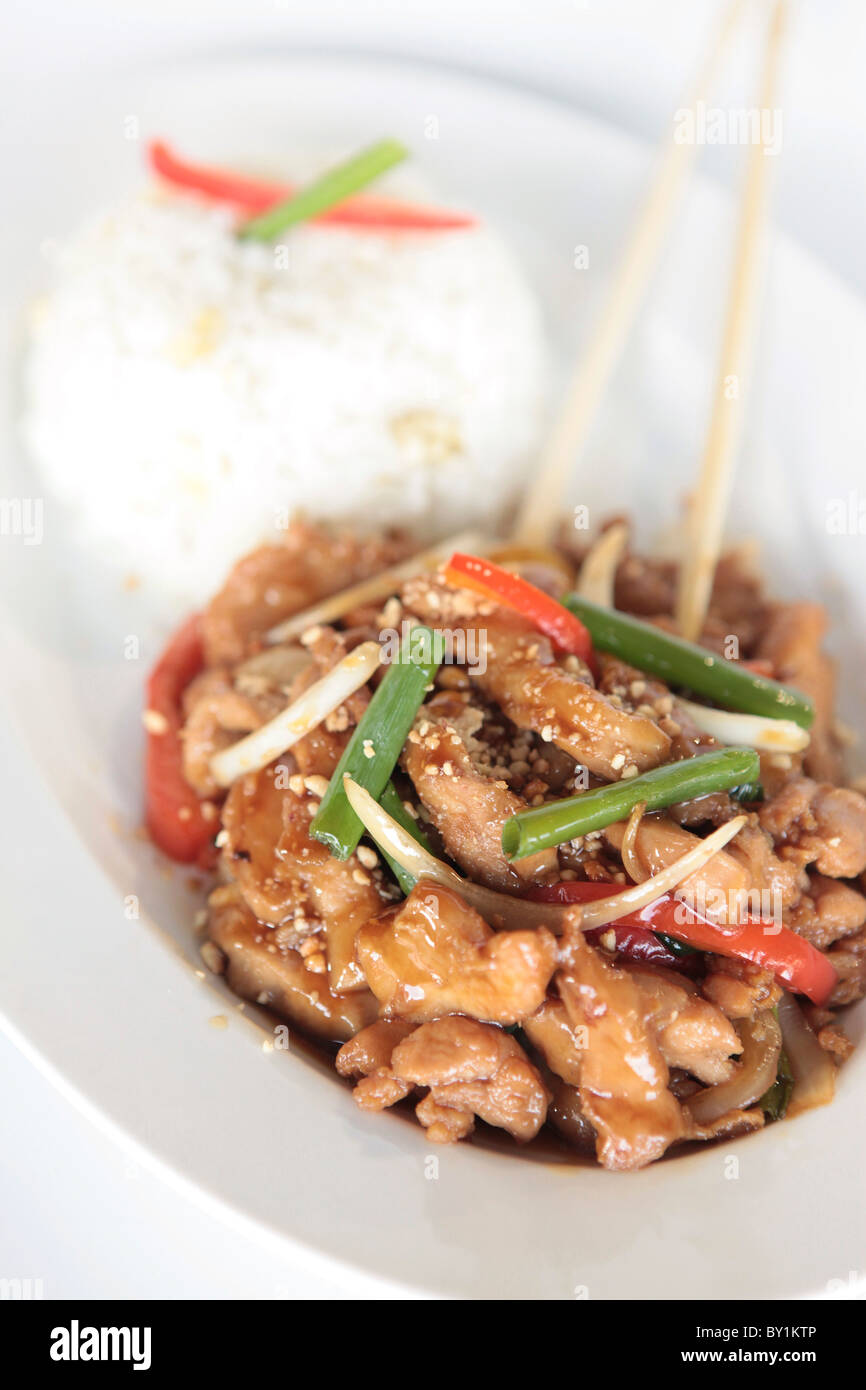 A plate of Chinese style stir fried chicken served with rice Stock Photo