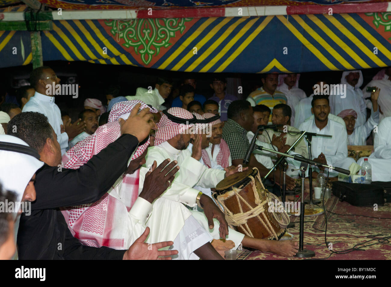 Saudi Arabian musician plays drum at traditional wedding celebration