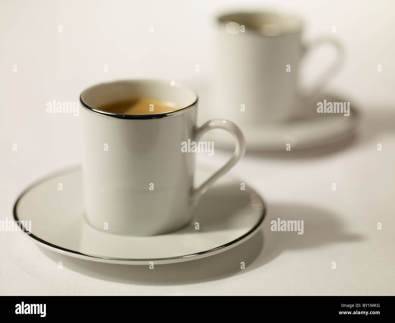 black coffee espresso in white cups with a silver gilt rim Stock Photo