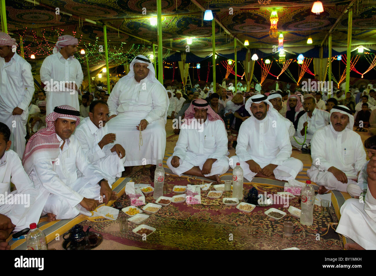 Guests enjoy meal at traditional Bedouin wedding celebration. El Tur, Sinai Peninsula, Egypt Stock Photo