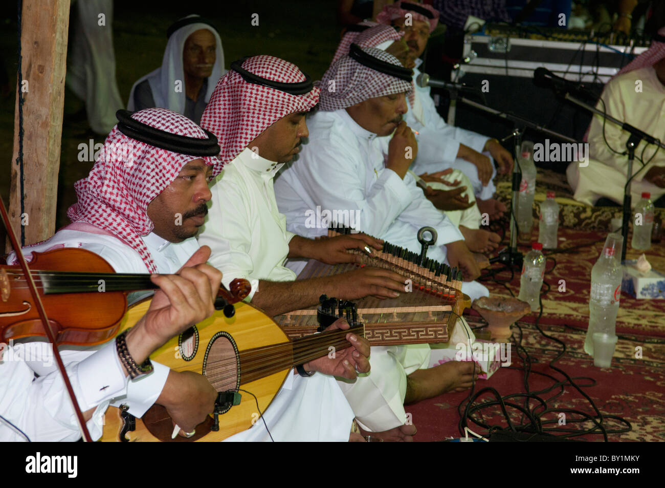 Saudi Arabian musicians play violin, oud and zither at traditional