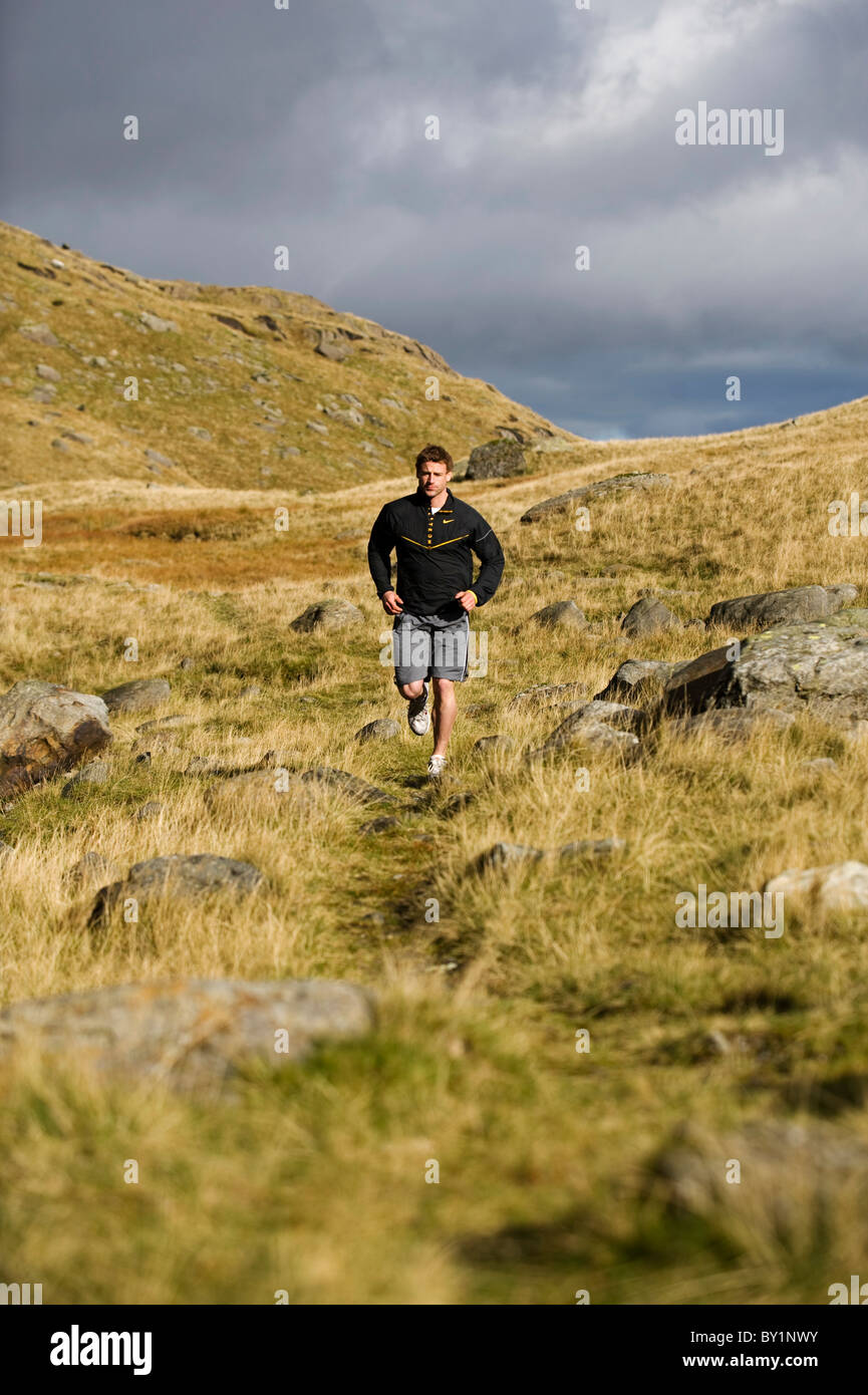 North Wales, Snowdonia.  Man running on the flanks of Mount Snowdon. (MR) Stock Photo