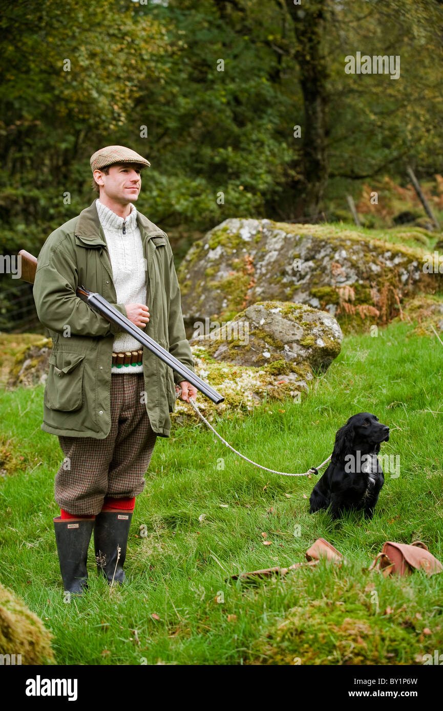 North Wales, Snowdonia ; Gilar Farm. A man with his dog out shooting.  (MR) Stock Photo