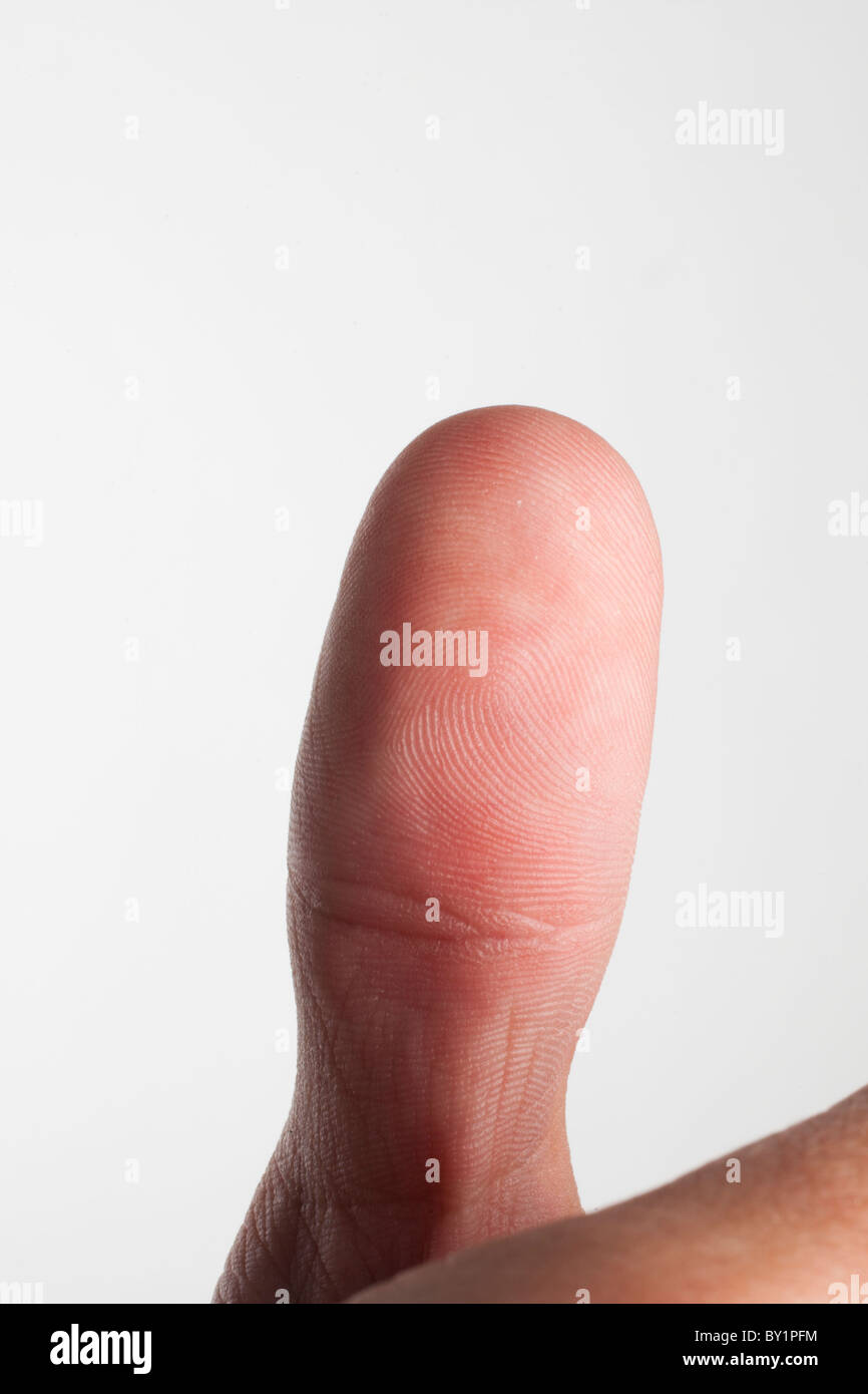 Close up of a thumb with fingerprint swirls visible Stock Photo